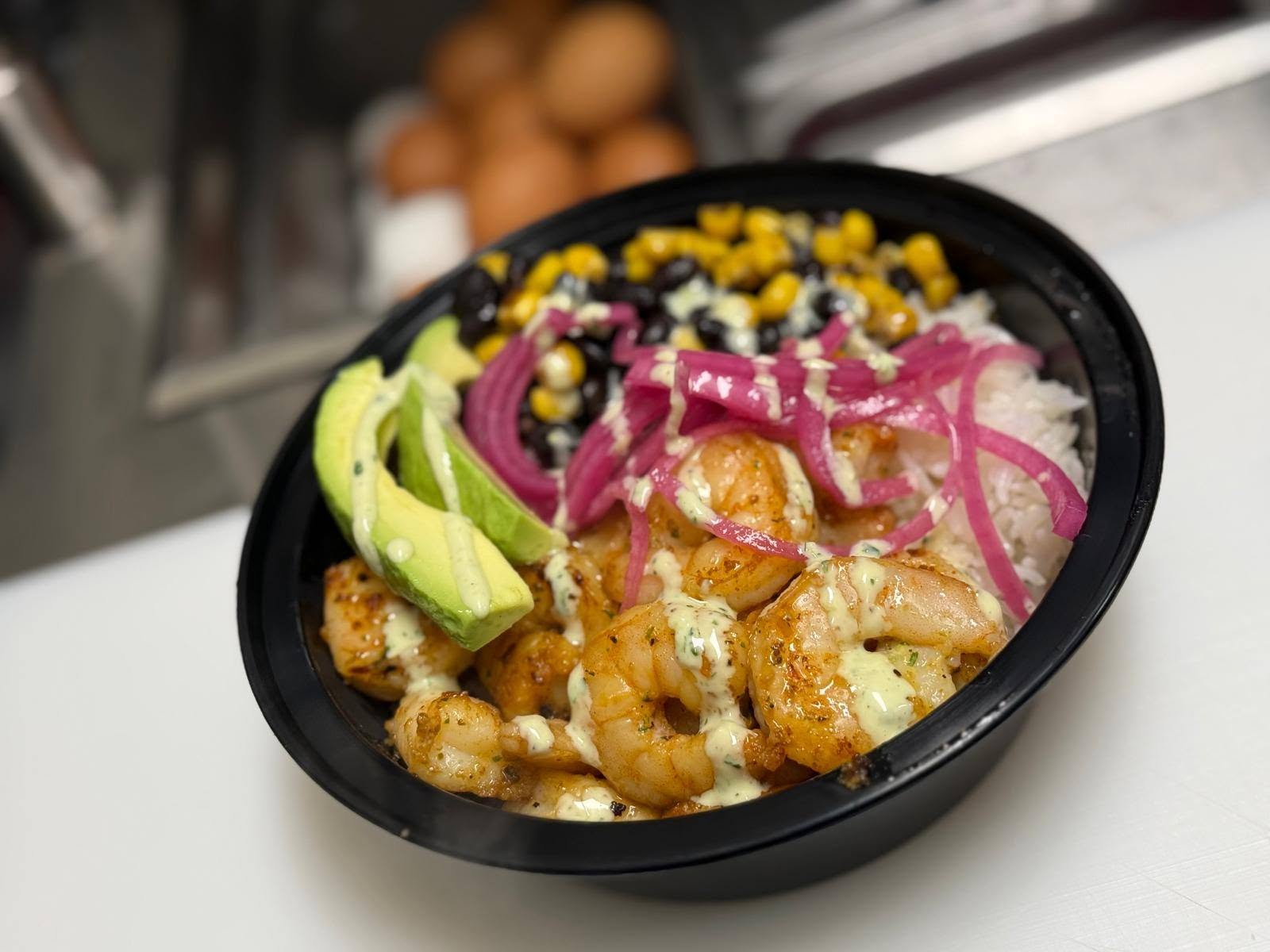 The Gulfport Bowl: grilled shrimp, pickled red onion, corn, black beans and avocado over rice